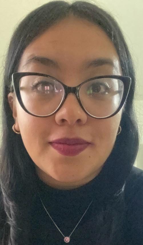 Professional real estate agent with long black hair, stylish glasses, hoop earrings, and minimalist jewelry representing Texas Signature Real Estate.