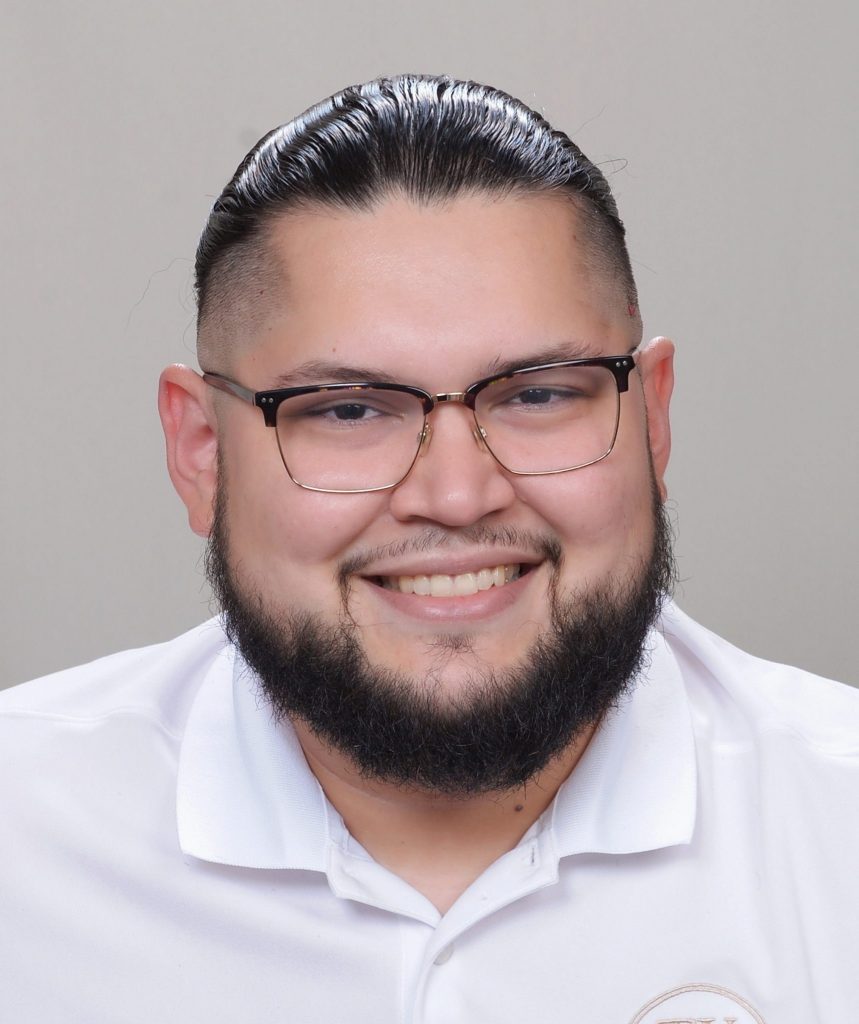 Professional headshot of a smiling real estate agent with dark hair, beard, glasses, and white shirt from Texas Signature Real Estate